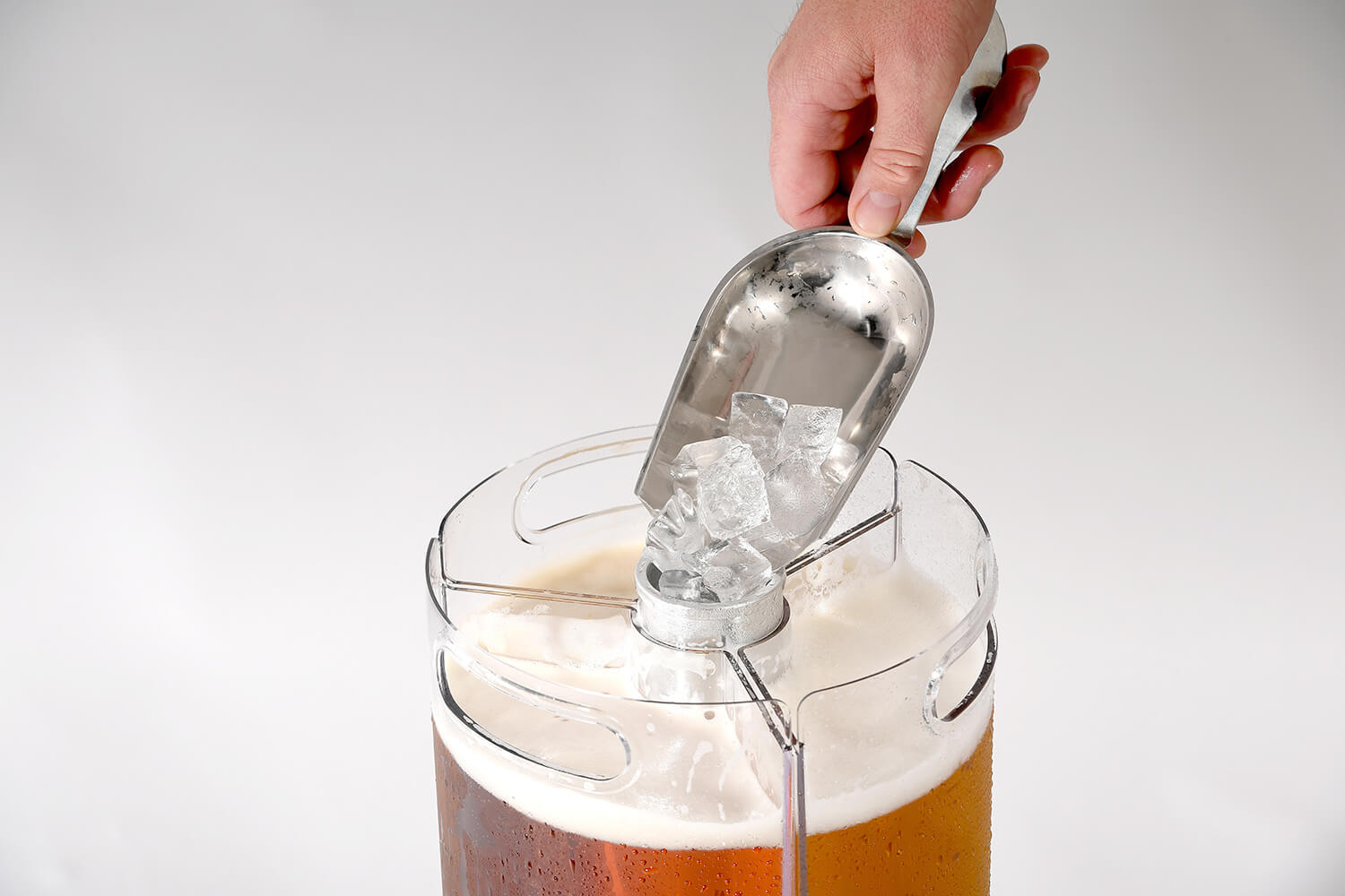 close-up of scoop dropping ice into centre core of team keg