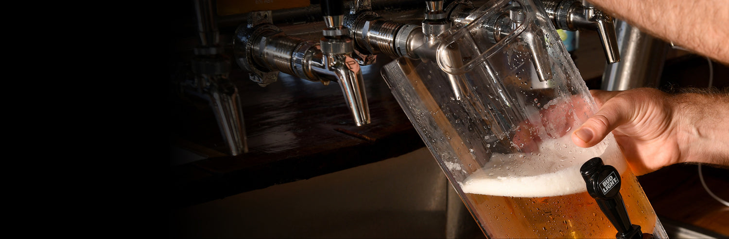 close up of beer taps pouring beer into a team keg jug