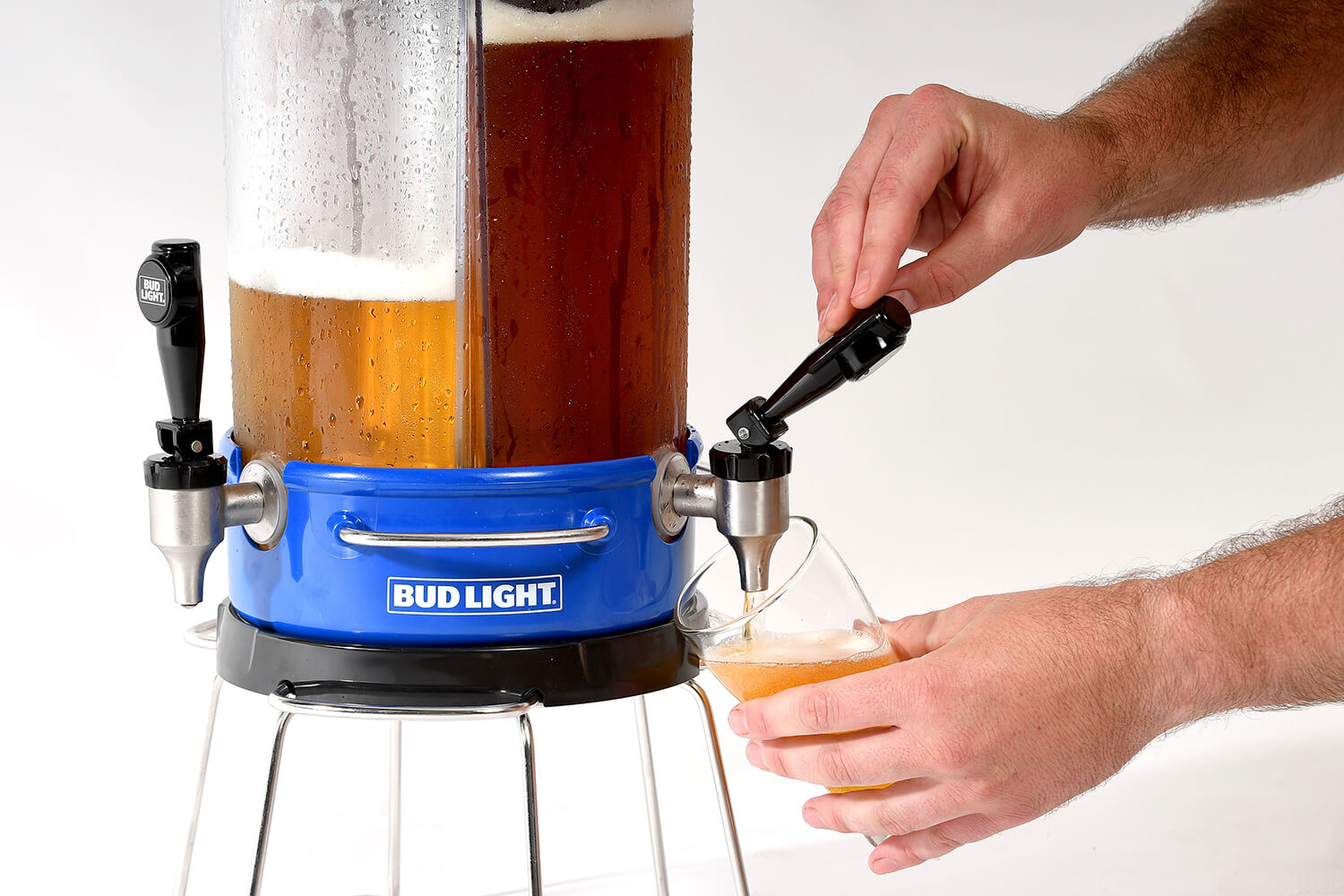 close-up of hand pulling tap and pouring beer from blue team keg